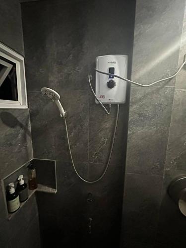 a bathroom with a blow dryer on a wall at Bilza A-House in Sagada