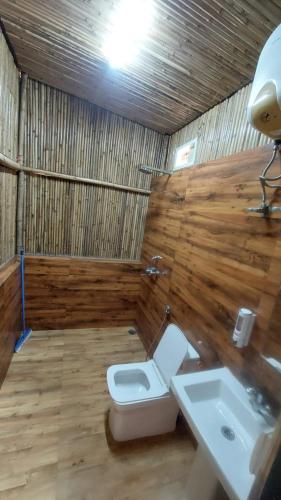 a bathroom with a toilet and a sink at Kutuumb Morni Hills in Morni