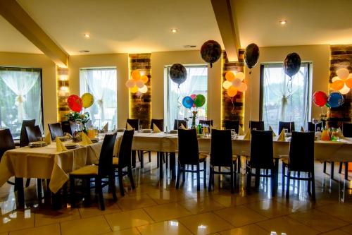 a banquet hall with tables and chairs and balloons at Pokoje BALDI Benelux in Skoczów