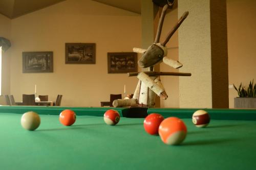 a green pool table with red balls on it at Pokoje BALDI Benelux in Skoczów