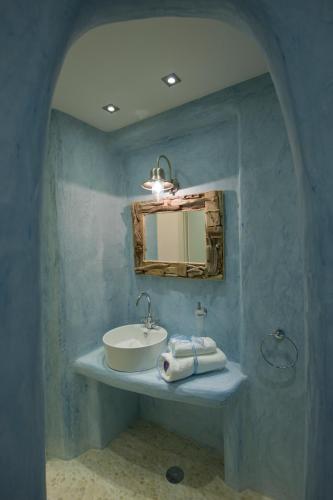 a bathroom with a sink and a mirror at Aegean Queen Villas - Onar Hotels Collection in Naousa