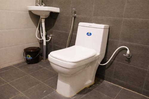 a bathroom with a toilet and a sink at The Bowers Chalet Private Campfire & Lawn BBQ, WIFI, Breakfast Hill Top 360 degree view in Ooty