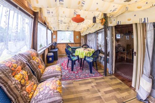 a dining room in an rv with a table and chairs at Campingplatz am Hünstein in Nohra