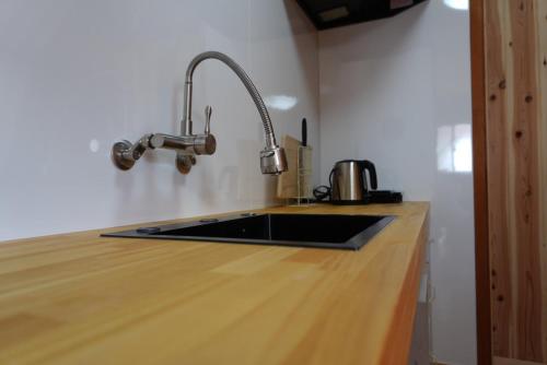 a kitchen with a sink and a counter top at コテージZen in Kyotango