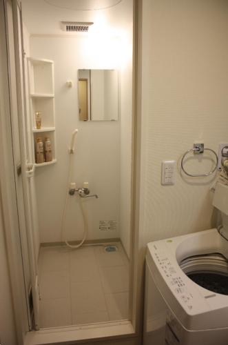 a bathroom with a shower and a toilet at Jasmine House in Tokyo