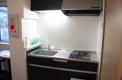 a small kitchen with a sink and a stove at Jasnine House in Tokyo