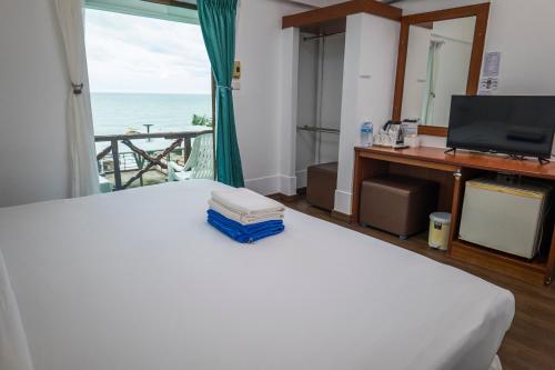 a bedroom with a bed with a view of the ocean at Mam Kaibae Hotel in Ko Chang