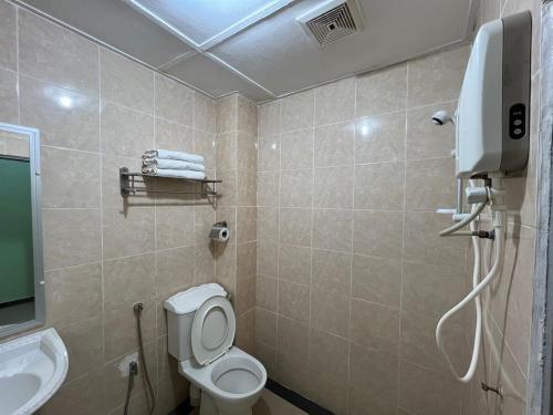 a bathroom with a toilet and a sink at Collection O Analisa Beach Resort in Pangkor