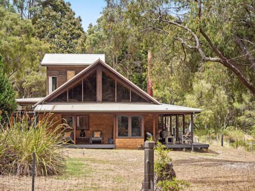 a house in the middle of a forest at Kookaburra Retreat - Dog Friendly - Forest View in Gnarabup