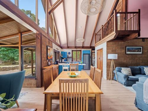 a kitchen and living room with a table and chairs at Kookaburra Retreat - Dog Friendly - Forest View in Gnarabup