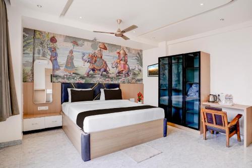 a bedroom with a bed and a painting on the wall at Super Townhouse Oak Dharwad New Bus Terminal Formerly Hotel Aditya Inn in Dhārwād