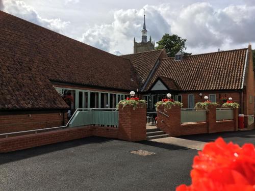 a row of houses with brick fences and flower boxes at Best Western The George Hotel, Swaffham in Swaffham
