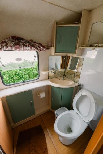a small bathroom with a toilet and a sink at Inthanon Mountain Camp in Ban Na Yang