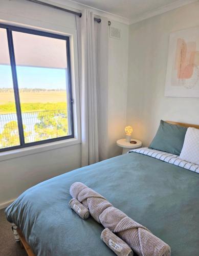 a bedroom with a bed with a large window at RiverBed Rise in Tailem Bend
