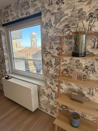 a room with a window and a wall with wallpaper at 1 bedroom appartement in the center of Rotterdam in Rotterdam