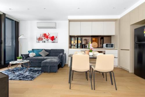 a living room with a couch and a table and chairs at The Quarter Elite 1BR Resort-Style Amenities in Melbourne