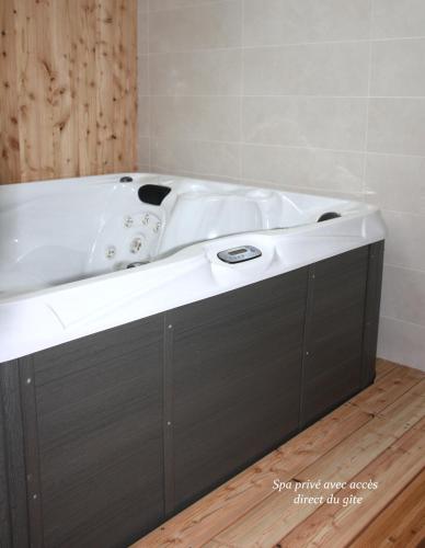 La salle de bains est pourvue d'une baignoire blanche. dans l'établissement La Grange de Jeanne, à Moosch