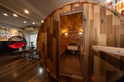 a room with a large wooden wall with a mirror at Doutonbori Crystal Exe in Osaka