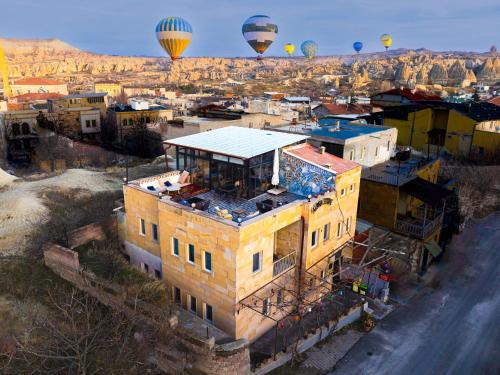 an aerial view of a city with hot air balloons at Alpha Stone House in Göreme