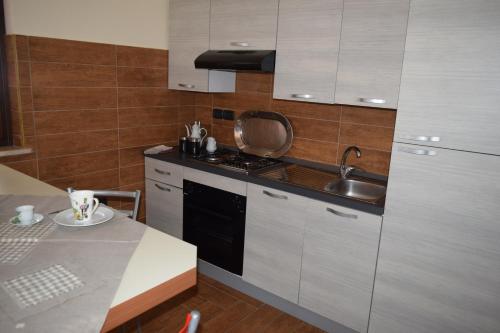 a kitchen with a sink and a stove top oven at Bed &Breakfast Pinetamare in Castel Volturno