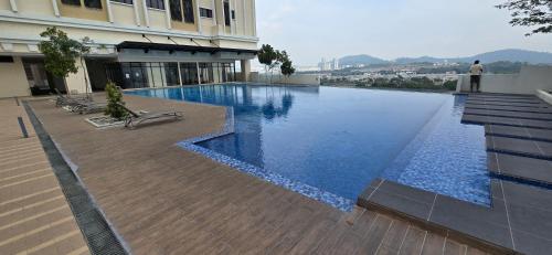 a large swimming pool on the side of a building at Setia Alam Homestay - Quiet High-Floor Studio in Shah Alam