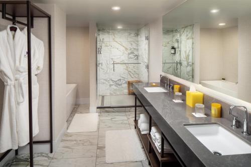 a bathroom with two sinks and a shower at Hyatt Regency Wichita in Wichita
