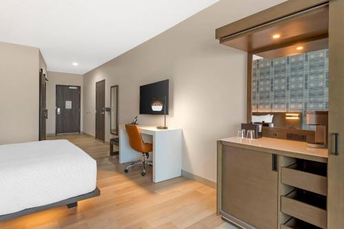 a bedroom with a bed and a desk at Cambria Hotel Fort Worth - Medical Center in Fort Worth