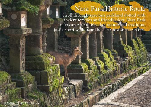 a deer standing next to a row ofestones at KAMENOI HOTEL Nara in Nara