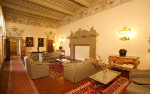 a living room filled with furniture and a fireplace at Hotel San Michele in Cortona