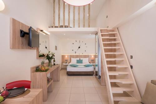 a bedroom with a bed and a staircase in a room at Sea & City Apartments in Chania
