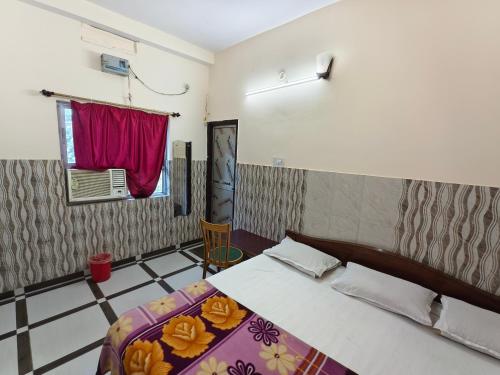 a bedroom with a bed and a window at Hotel Vijay in Rājgīr