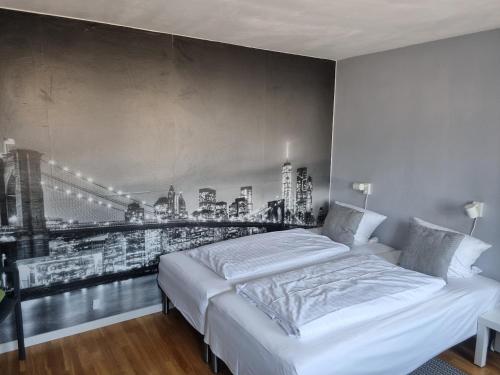 a bedroom with a bed with a picture of a city at Vestbjerg Apartments in Vestbjerg