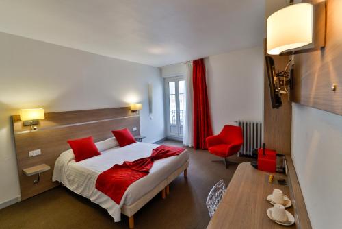 a hotel room with a bed and a red chair at Hôtel de l'Europe Grenoble hyper-centre in Grenoble