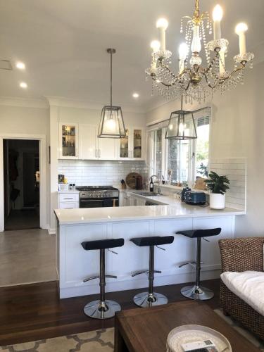 a kitchen with a large island with bar stools at Hills Manor House in Greenmount
