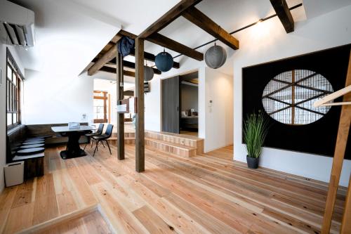 an open living room with wooden floors and a large window at AWAJI PRIVATE Villa 神蔵-KAGURA in Awaji