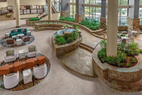 a lobby with tables and chairs in a building at Embassy Suites San Antonio Riverwalk-Downtown in San Antonio