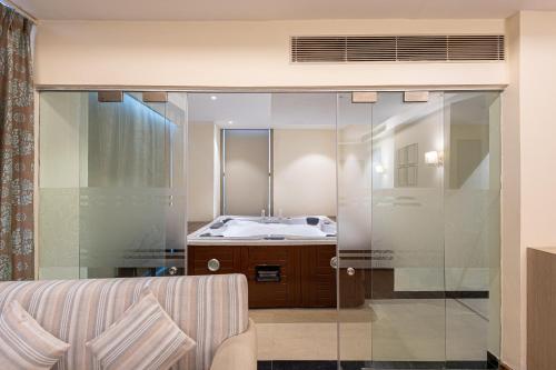 a bathroom with a sink and a glass shower at The BellaVista Hotel Chandigarh Panchkula in Chandīgarh