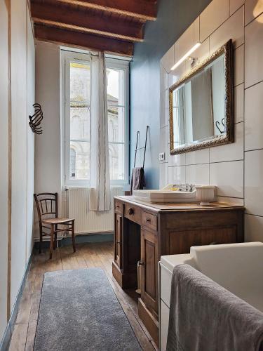 a bathroom with a sink and a mirror at Une nuit à la Clouère in Saint-Maurice-la-Clouère