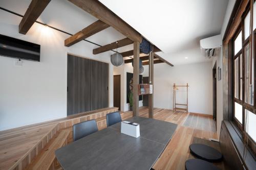 a dining room with a table and chairs in a room at AWAJI PRIVATE Villa 神蔵-KAGURA in Awaji