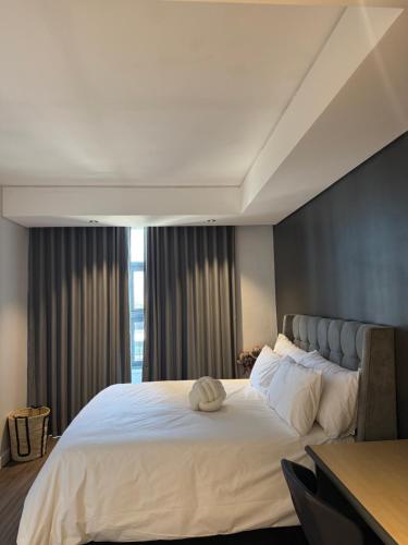 a bedroom with a large bed with a large window at Enzo Stay -The Matrix 505 , Century City in Cape Town