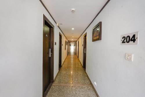 a long hallway with a number on the wall at FabHotel Upstream Mysore Road in Bangalore