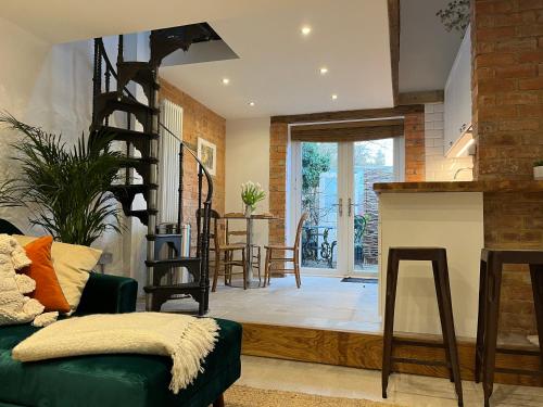 a living room with a green couch and a table at The Forge in Towcester