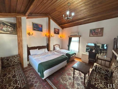 a bedroom with two beds and a television in it at ARİFBEY KONAGİ otel in Şahinbey