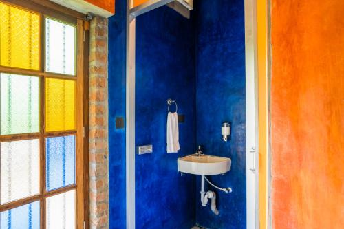 a bathroom with a sink and a blue wall at goSTOPS Pondicherry Near Auroville in Auroville