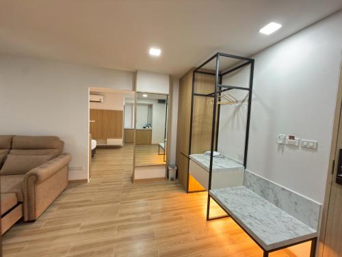 a living room with a couch and a glass case at Armass Residence in Bangna