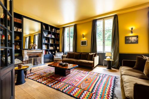 a living room with a couch and a fireplace at chalet baron in Lormont
