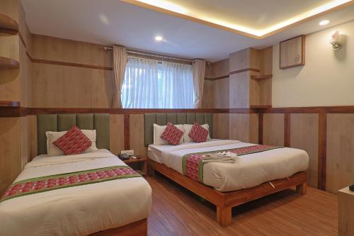 a hotel room with two beds and a window at OYO 839 Hotel Middle Temple in Kathmandu
