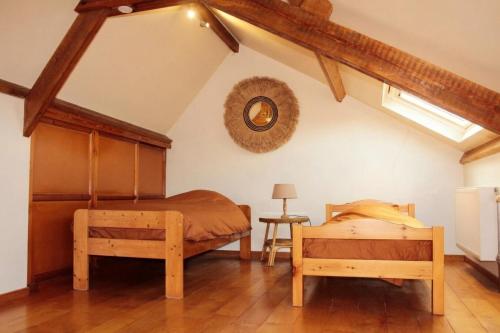 a bedroom with two beds and a table at La Maisonnette - 2 chambres, parking, jardinet & calme in Tournai