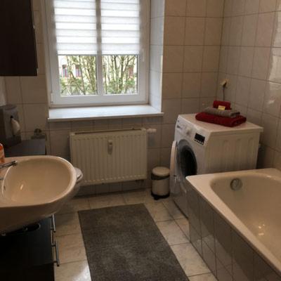 a bathroom with a sink and a washing machine at APARTHOTEL 1A in Zwickau