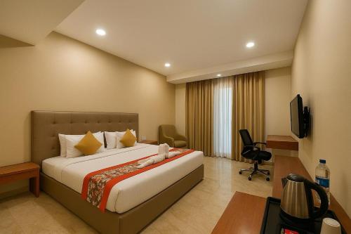 a hotel room with a bed and a television at Comfort By Choice in Amritsar